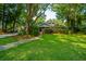 Charming home with lush lawn, mature trees and inviting walkway at 802 Robert E. Lee Blvd, Charleston, SC 29412