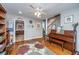Comfortable living room showing hardwood floors, piano, and views to the kitchen and staircase at 802 Robert E. Lee Blvd, Charleston, SC 29412