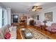 Open concept living room with hardwood floors, ceiling fan, and an archway leading to the dining area at 802 Robert E. Lee Blvd, Charleston, SC 29412