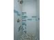 Modern walk-in shower with pebble floor, built-in niche, and sleek tile design at 802 Robert E. Lee Blvd, Charleston, SC 29412