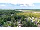 A lush landscape surrounds this beautiful home with mature trees and an inviting green space at 8320 Tyrian Path, North Charleston, SC 29418