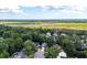 Beautiful aerial view of a landscaped home surrounded by lush greenery and a scenic river at 8320 Tyrian Path, North Charleston, SC 29418