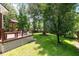 Spacious backyard view featuring a deck with outdoor kitchen, seating, and an inground pool for outdoor entertaining at 8320 Tyrian Path, North Charleston, SC 29418