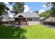 Spacious backyard featuring a wooden deck, fenced yard, and well-maintained lawn at 8320 Tyrian Path, North Charleston, SC 29418