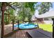 Backyard deck with a hot tub and an inground pool perfect for outdoor enjoyment and entertaining at 8320 Tyrian Path, North Charleston, SC 29418