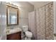 Functional bathroom featuring a toilet, sink, and a shower with a decorative shower curtain at 8320 Tyrian Path, North Charleston, SC 29418