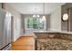 Dining area adjacent to the kitchen with hardwood floors, ample natural light, and neutral decor at 8320 Tyrian Path, North Charleston, SC 29418