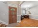 Inviting foyer with hardwood floors, a piano, and a charming half-glass front door at 8320 Tyrian Path, North Charleston, SC 29418