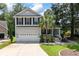 Charming two-story home featuring a well-manicured lawn, attached garage, and inviting front porch at 8320 Tyrian Path, North Charleston, SC 29418