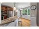 Breakfast bar and dining area with large windows, hardwood floors, and granite countertops at 8320 Tyrian Path, North Charleston, SC 29418