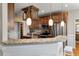 Kitchen with granite countertops, pendant lighting, stainless steel appliances, and dark wood cabinetry at 8320 Tyrian Path, North Charleston, SC 29418