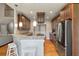 Bright kitchen with granite counters, bar seating, stainless steel appliances, and wood cabinets at 8320 Tyrian Path, North Charleston, SC 29418