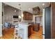Open kitchen view with bar seating, granite counters, stainless appliances, and access to the living room at 8320 Tyrian Path, North Charleston, SC 29418