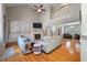 Bright and airy living room featuring a high ceiling, hardwood floors, fireplace, and staircase at 8320 Tyrian Path, North Charleston, SC 29418