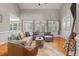 Bright living room with hardwood floors, large windows, and a comfortable seating area at 8320 Tyrian Path, North Charleston, SC 29418