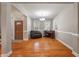 Cozy living room with hardwood floors, a comfortable armchair, and a piano near the front door at 8320 Tyrian Path, North Charleston, SC 29418