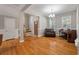 Living room with hardwood floors, neutral paint, natural light, piano, and stairs at 8320 Tyrian Path, North Charleston, SC 29418