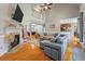 Open concept living room featuring a fireplace, hardwood floors, and ample natural light at 8320 Tyrian Path, North Charleston, SC 29418