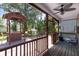 Screened porch showing a ceiling fan, grill, and wooded backyard views, perfect for relaxing and entertaining at 8320 Tyrian Path, North Charleston, SC 29418