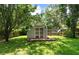 A screened shed with small deck in a backyard is perfect for storage or conversion to playhouse at 8320 Tyrian Path, North Charleston, SC 29418