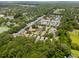 Scenic aerial view of community with ponds, tree-lined streets, and charming homes, soccer field included at 907 High Nest Ln, Charleston, SC 29412