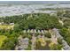Aerial view of waterfront community surrounded by lush greenery featuring neatly arranged homes and tranquil ponds at 907 High Nest Ln, Charleston, SC 29412