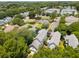 An aerial view of houses with gray roofs and well-manicured lawns surrounding a serene pond at 907 High Nest Ln, Charleston, SC 29412