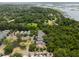 Neighborhood aerial view showing quaint homes nestled among dense trees near a pond and marshy waterways at 907 High Nest Ln, Charleston, SC 29412