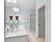 Bright bathroom featuring a double sink vanity, decorative vases and a glass enclosed shower with tiled walls at 907 High Nest Ln, Charleston, SC 29412