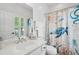Bright bathroom featuring a single sink vanity, window with shutters and a shower with a decorative curtain at 907 High Nest Ln, Charleston, SC 29412