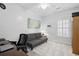 Bedroom featuring a gray futon, wood desk, neutral carpet and white walls for a bright space at 907 High Nest Ln, Charleston, SC 29412