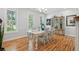 Bright dining room featuring a large table, decorative cabinet, and ample natural light through shuttered windows at 907 High Nest Ln, Charleston, SC 29412