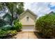 Charming home featuring a two-car garage surrounded by lush landscaping and mature trees at 907 High Nest Ln, Charleston, SC 29412
