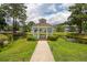 Picturesque gazebo over pond surrounded by lush greenery and charming neighborhood homes at 907 High Nest Ln, Charleston, SC 29412