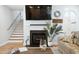 Bright living room with fireplace, TV, and staircase view, plus stylish decor and comfortable seating at 907 High Nest Ln, Charleston, SC 29412