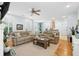 Open living room with hardwood floors, comfortable sofas, and views of the kitchen and dining area at 907 High Nest Ln, Charleston, SC 29412