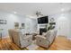 Spacious living room with hardwood floors, a fireplace, comfortable seating, and natural light at 907 High Nest Ln, Charleston, SC 29412