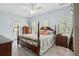 Serene main bedroom featuring a four-poster bed, soft lighting, and ample natural light from shuttered windows at 907 High Nest Ln, Charleston, SC 29412