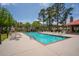 A serene community swimming pool with lounge chairs, tables, and a pergola for shade at 907 High Nest Ln, Charleston, SC 29412