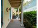 Covered porch with wood flooring and views of the well-kept yard and neighboring house at 907 High Nest Ln, Charleston, SC 29412