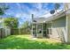 Spacious backyard with a screened-in porch and a well-maintained lawn, perfect for outdoor enjoyment at 9255 Ayscough Rd, Summerville, SC 29485