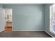 Spacious bedroom with neutral paint, large window, and adjacent room with a bamboo table at 9255 Ayscough Rd, Summerville, SC 29485