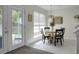Bright breakfast nook featuring a round table with seating for four and a sliding glass door at 9255 Ayscough Rd, Summerville, SC 29485
