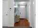Hallway featuring wood floors and neutral walls. Includes a view of the home's front door at 9255 Ayscough Rd, Summerville, SC 29485
