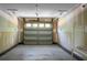 Spacious two car garage featuring a neutral paint palette, concrete floor, and large paneled garage door with windows at 9255 Ayscough Rd, Summerville, SC 29485