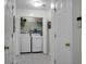 Laundry room with white washer and dryer, shelving, and a folding door at 9255 Ayscough Rd, Summerville, SC 29485