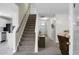 Carpeted staircase leads to the upper level, complemented by a wooden railing and neutral color scheme at 9255 Ayscough Rd, Summerville, SC 29485