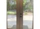 View of a backyard with a patio and green grass as seen from inside the home through french doors at 963 Yorktown Dr, Charleston, SC 29412