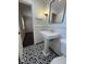 Elegant bathroom with pedestal sink, bold patterned floor, and modern fixtures at 963 Yorktown Dr, Charleston, SC 29412