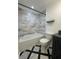 Modern bathroom with tub, marbled tile, and stylish black and white accents at 963 Yorktown Dr, Charleston, SC 29412